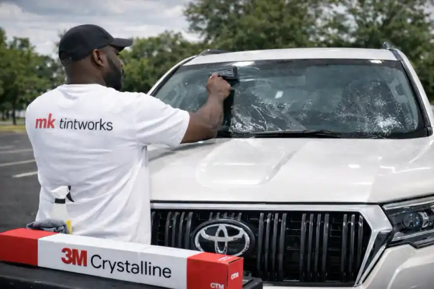 3M Crystalline windshield film being installed on a premium SUV